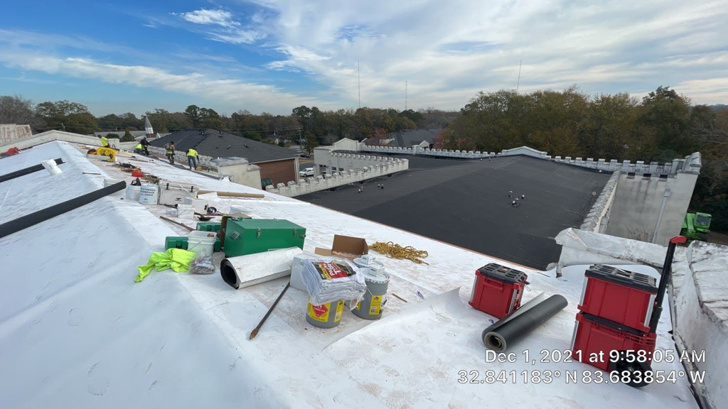 Alan Frank employees working on school roof